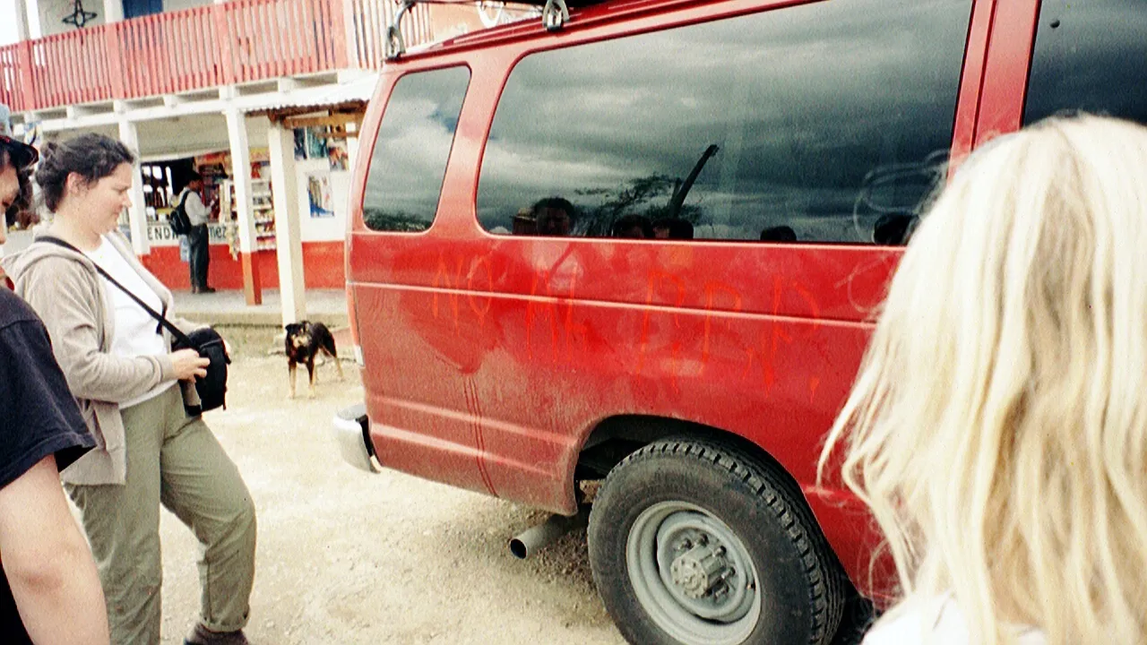 Marion looks on at the remaining bits of the spray paint on the van