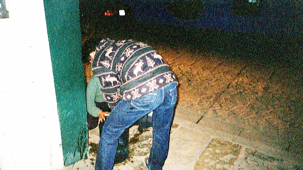 The store (Tosh filling the bottle with a kid helping him behind)